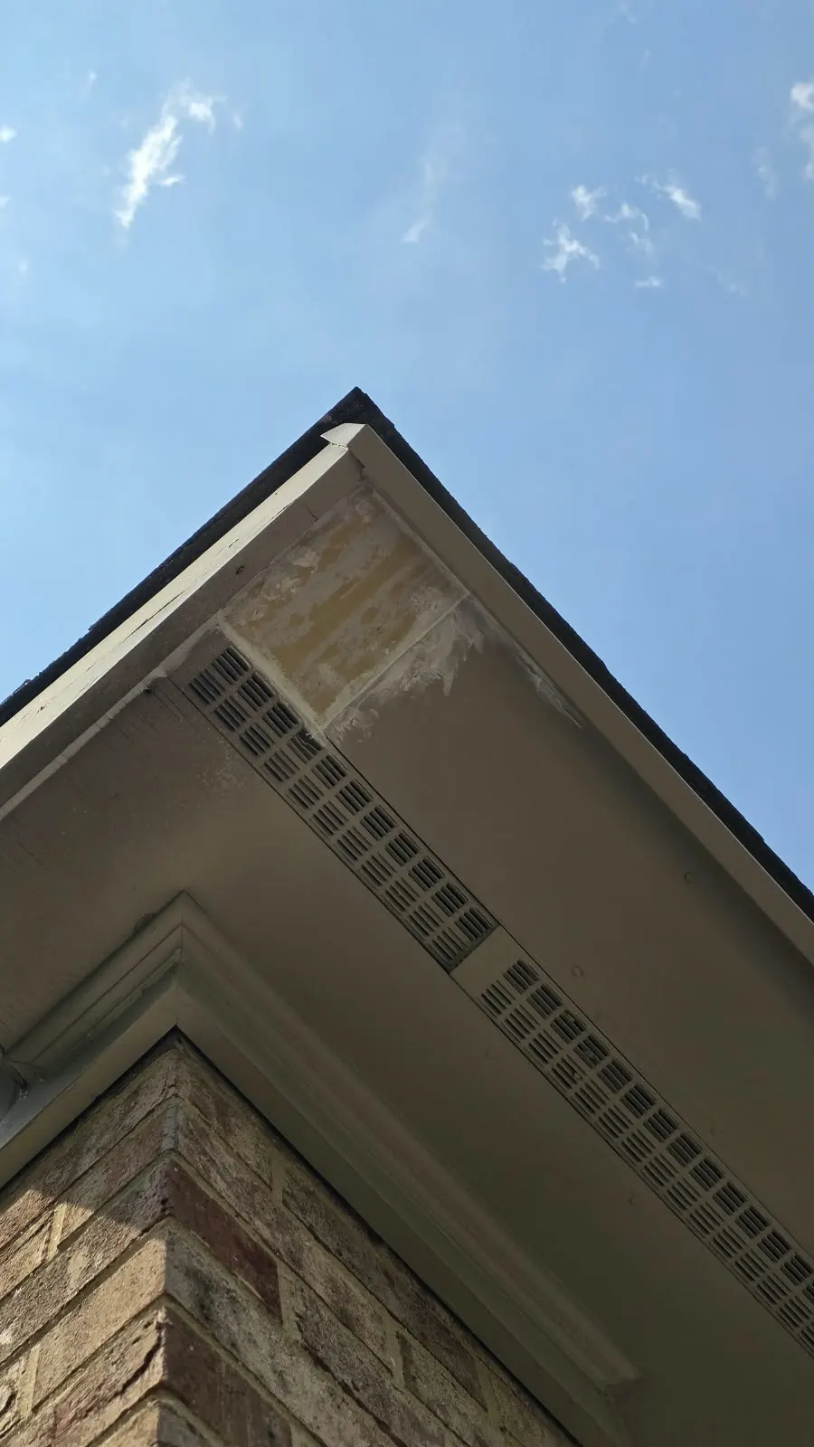Fascia and soffit trim on a brick home prepared for painting in Hampton, VA