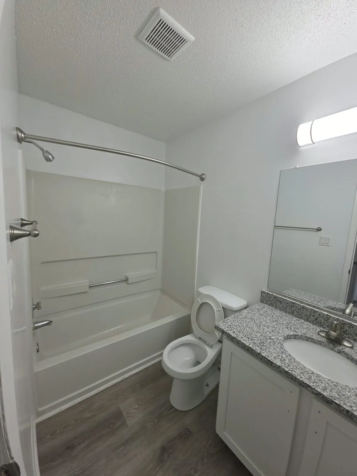 Tub and shower surround with a granite vanity top, bathroom remodel in Hampton, VA