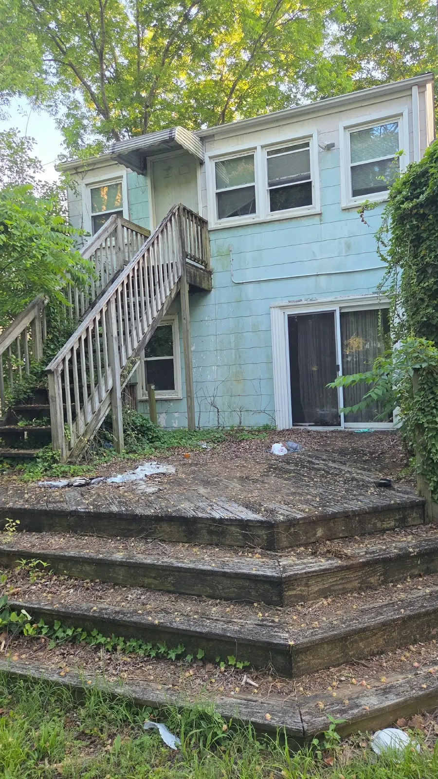 Rear wood stairs and landing on an older house before rebuilding in Hampton, VA